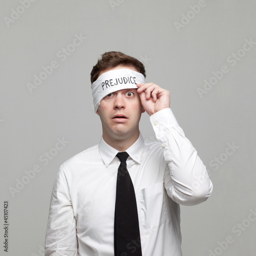 Photo: Studio portrait of young man with blindfold Studio portrait of young man with blindfold