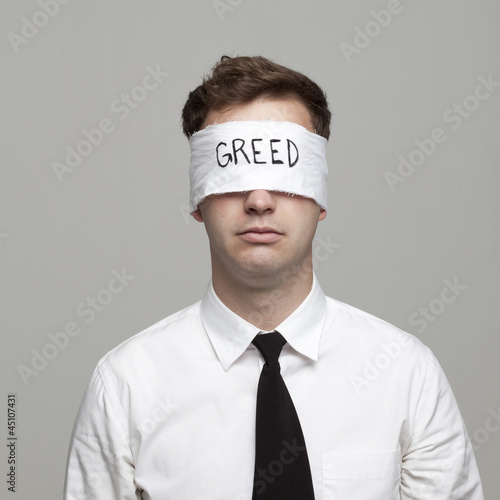 Photo: Studio portrait of young man with blindfold Studio portrait of young man with blindfold