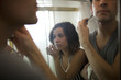 Photo: "USA, Utah, Provo, Close-up of young couple in front of bathroom mirror" "USA, Utah, Provo, Close-up of young couple in front of bathroom mirror"