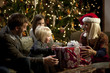 "USA, Utah, Cedar Hills, Three generation family with girls (2-3, 8-9) opening Christmas presents"