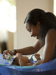 "USA, Utah, Cedar Hills, Mother bathing newborn baby boy ( 0-1 months)"
