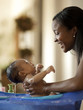 "USA, Utah, Cedar Hills, Mother bathing newborn baby boy ( 0-1 months)"