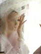 "USA, Utah, Cedar Hills, Woman looking into mirror covered with steam"