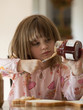 "USA, Utah, Cedar Hills, Girl (4-5) putting jam on bread"