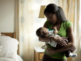 Photo: "USA, Utah, Cedar Hills, Mother with newborn baby boy ( 0-1 months) sleeping in her hands" "USA, Utah, Cedar Hills, Mother with newborn baby boy ( 0-1 months) sleeping in her hands"