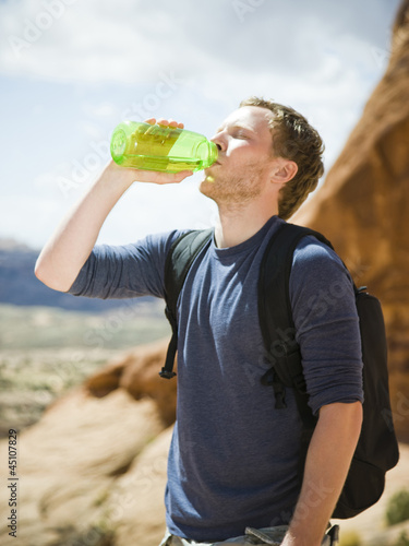 Photo: man drinking water in the desert man drinking water in the desert