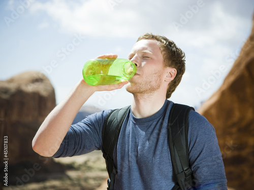 Photo: man drinking water in the desert man drinking water in the desert