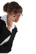 Critical woman peering over her glasses