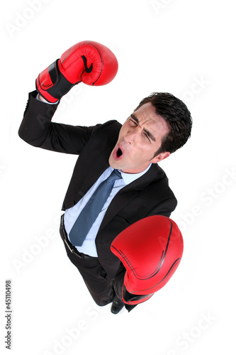Photo: Businessman wearing boxing gloves Businessman wearing boxing gloves