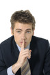 doing a silence gesture with his forefinger