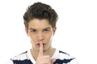 doing a silence gesture with his forefinger