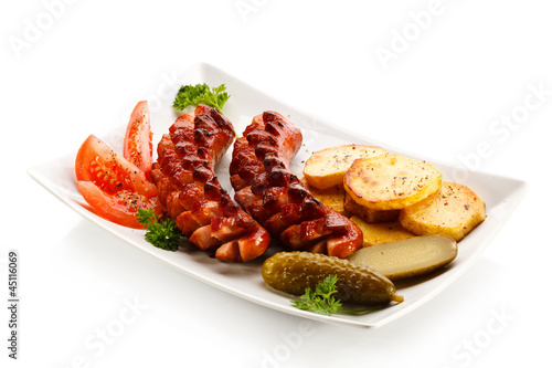 Photo: Grilled sausages, baked potatoes and vegetables Grilled sausages, baked potatoes and vegetables