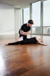 Fitness Trainer Assisting Woman In Gym