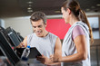 Instructor With Client In Health Club