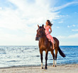 girl with horse on seacoast
