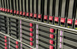 Row of hard drives mounted in a rack in a data center