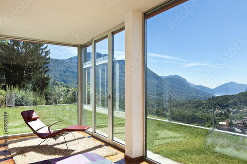 Photo: beautiful house, modern style, room view with a chair beautiful house, modern style, room view with a chair