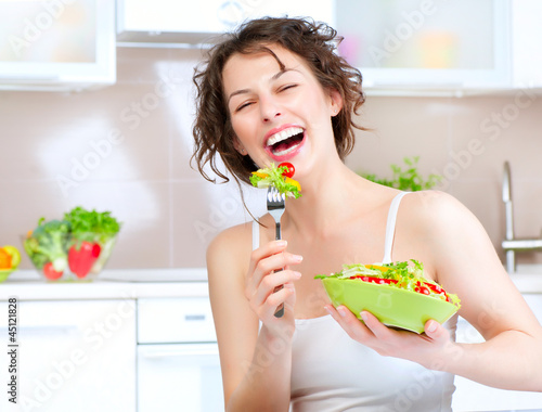 Photo: Diet. Beautiful Young Woman Eating Vegetable Salad Diet. Beautiful Young Woman Eating Vegetable Salad