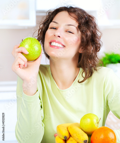 Photo: Diet. Happy Young Woman Eating Fresh Fruit Diet. Happy Young Woman Eating Fresh Fruit