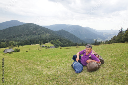 Photo: Sedentary tourist in mountains Carpathians. Sedentary tourist in mountains Carpathians.