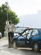 Foto: people looking at a car after an accident people looking at a car after an accident