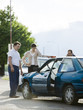 Foto: people looking at a car after an accident people looking at a car after an accident