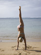 woman doing a handstand in a bikini