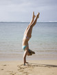 woman doing a handstand in a bikini