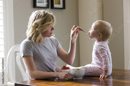 Photo: mother and baby girl at the breakfast table mother and baby girl at the breakfast table