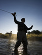 fly fisherman fishing in a mountain river