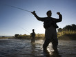 fly fisherman fishing in a mountain river