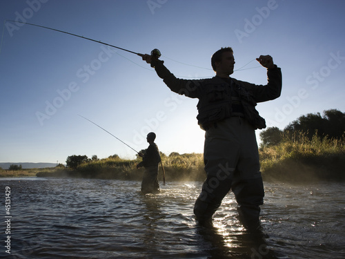 Photo: fly fisherman fishing in a mountain river fly fisherman fishing in a mountain river