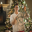 man untangling christmas tree lights