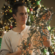 man untangling christmas tree lights