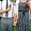 "USA, Utah, Salt Lake City, Young couple with halves of beetroots in place of heart, midsection"