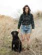 "USA, Utah, Orem, Portrait of young woman posing with dog"