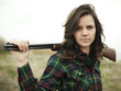 "USA, Utah, Orem, Portrait of young woman holding rifle"