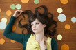 Portrait of young woman against wooden background with decoration