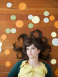 Portrait of young woman against wooden background with decoration