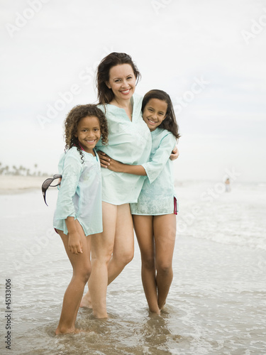 Photo: "USA, California, Los Angeles, Portrait of mother with daughters (6-11) on beach" "USA, California, Los Angeles, Portrait of mother with daughters (6-11) on beach"