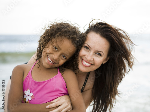 Photo: "USA, California, Los Angeles, Portrait of mother and daughter (6-7) on beach" "USA, California, Los Angeles, Portrait of mother and daughter (6-7) on beach"