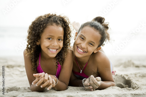 Photo: "USA, California, Los Angeles, Portrait of two girls (6-11) on beach" "USA, California, Los Angeles, Portrait of two girls (6-11) on beach"