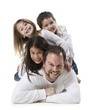 father and three children lying on top of each other