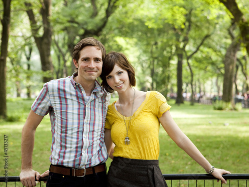 Photo: "USA, New York, New York City, Portrait of young couple in park" "USA, New York, New York City, Portrait of young couple in park"