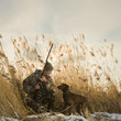 man and his dog duck hunting