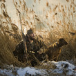 man and his dog duck hunting