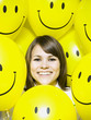 woman with smiley face balloons