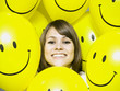 woman with smiley face balloons