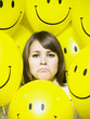 woman with smiley face balloons