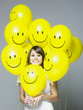 woman with smiley face balloons